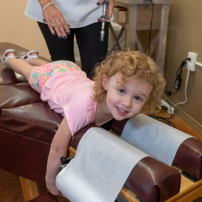 Chiropractor Bernalillo shoulder-adjustment toddler-on-table Chiropractor Bernalillo